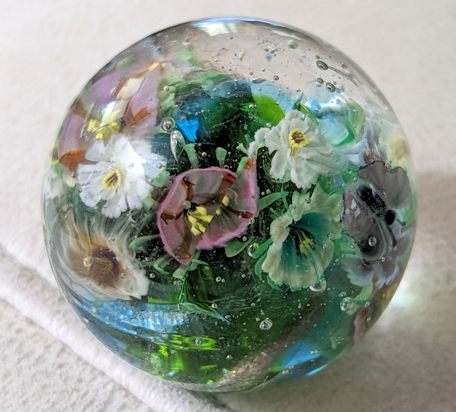1.75 inch Marble that cracked going into the kiln, reheated and sort of healed.  Can you see the cracked flower?